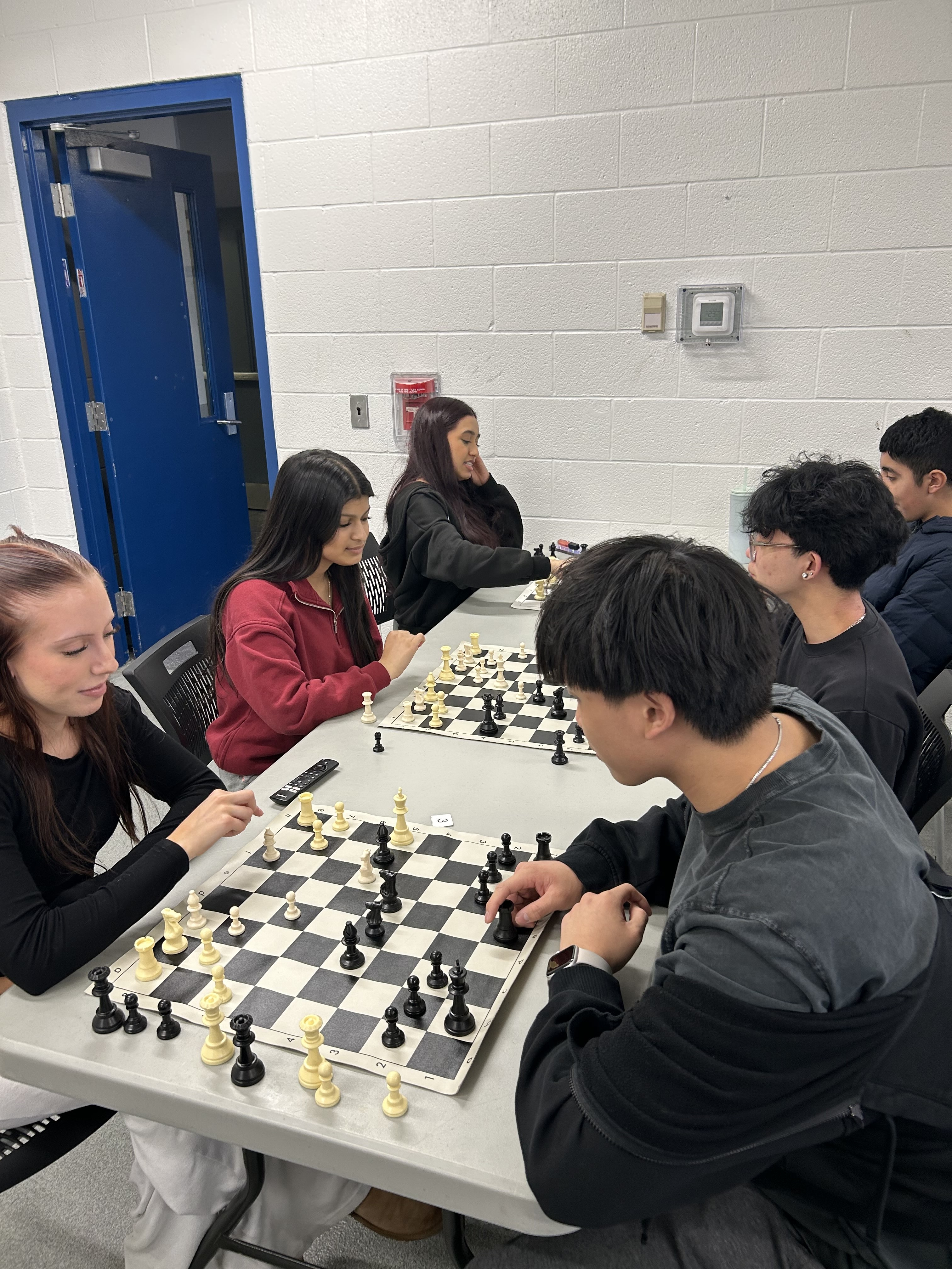 2 highschool players engaging in chess
